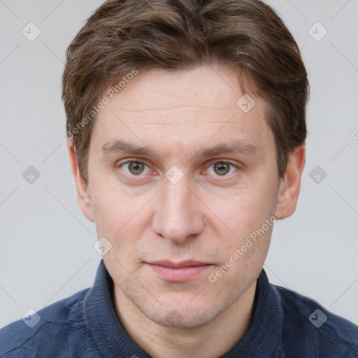 Joyful white adult male with short  brown hair and grey eyes