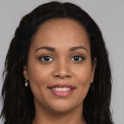 Joyful latino young-adult female with long  brown hair and brown eyes