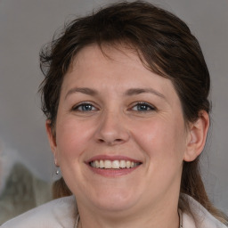 Joyful white adult female with medium  brown hair and brown eyes