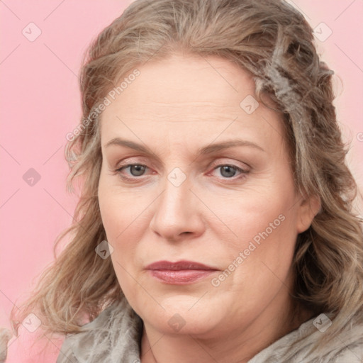 Joyful white adult female with medium  brown hair and blue eyes