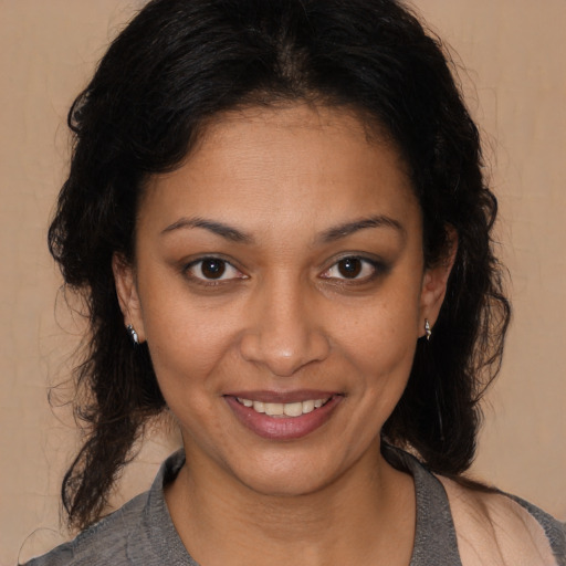 Joyful black young-adult female with medium  brown hair and brown eyes