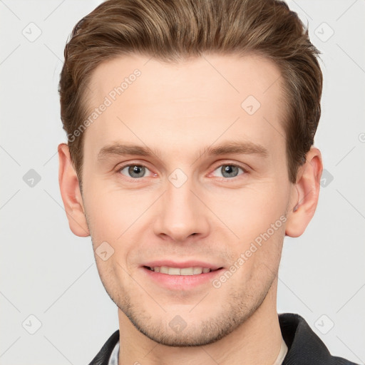 Joyful white young-adult male with short  brown hair and grey eyes