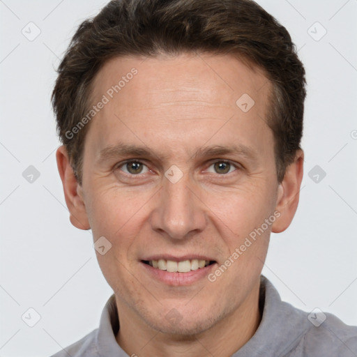 Joyful white adult male with short  brown hair and grey eyes