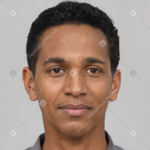 Joyful black adult male with short  black hair and brown eyes