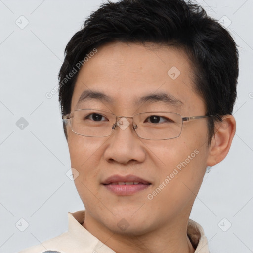 Joyful asian adult male with short  brown hair and brown eyes