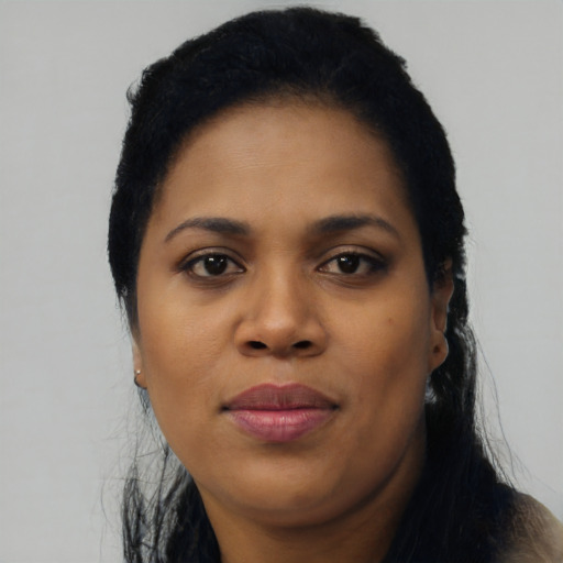 Joyful black young-adult female with long  black hair and brown eyes