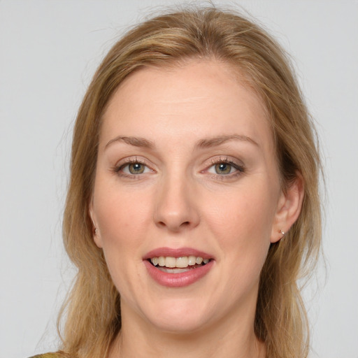 Joyful white adult female with medium  brown hair and green eyes