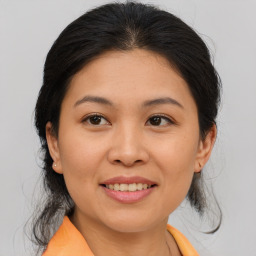 Joyful asian young-adult female with medium  brown hair and brown eyes