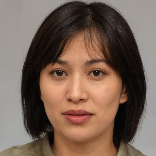 Joyful white young-adult female with medium  brown hair and brown eyes