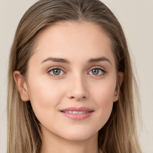 Joyful white young-adult female with long  brown hair and grey eyes