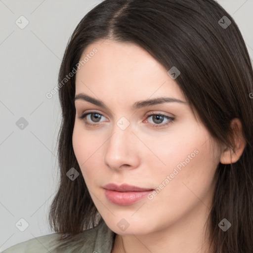 Neutral white young-adult female with long  brown hair and brown eyes