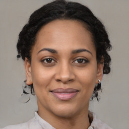 Joyful latino adult female with medium  brown hair and brown eyes