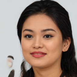 Joyful asian young-adult female with long  brown hair and brown eyes