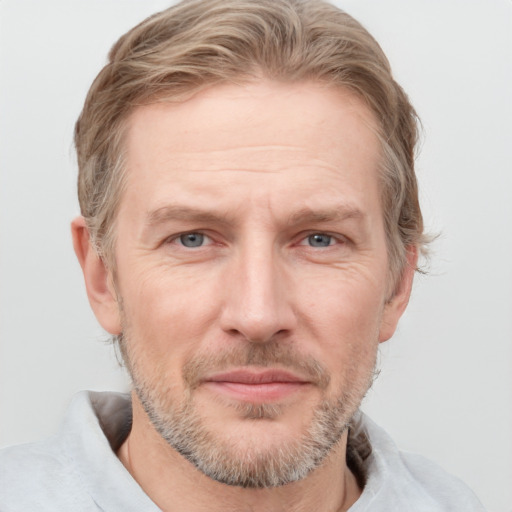 Joyful white adult male with short  brown hair and grey eyes