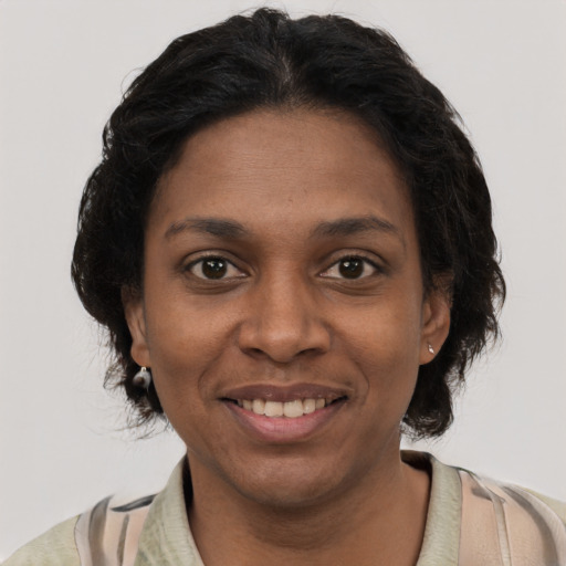 Joyful black young-adult female with short  black hair and brown eyes