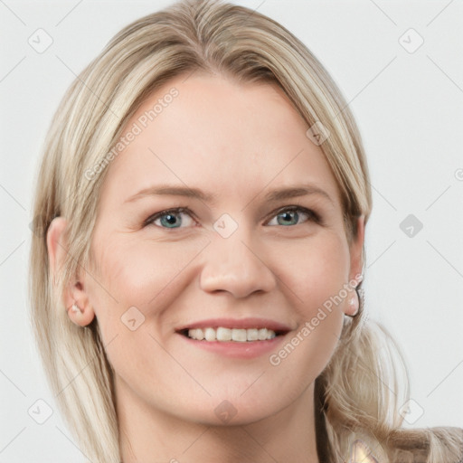 Joyful white young-adult female with long  blond hair and blue eyes