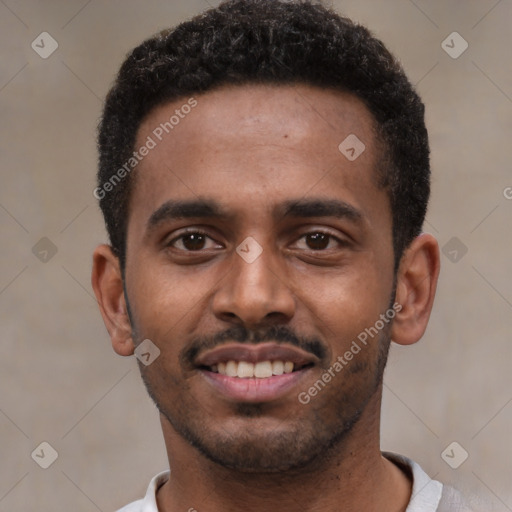 Joyful black young-adult male with short  black hair and brown eyes