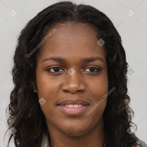 Joyful black young-adult female with long  brown hair and brown eyes