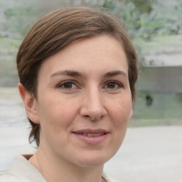 Joyful white adult female with short  brown hair and grey eyes