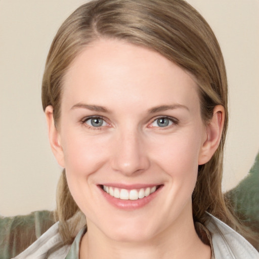 Joyful white young-adult female with medium  brown hair and blue eyes