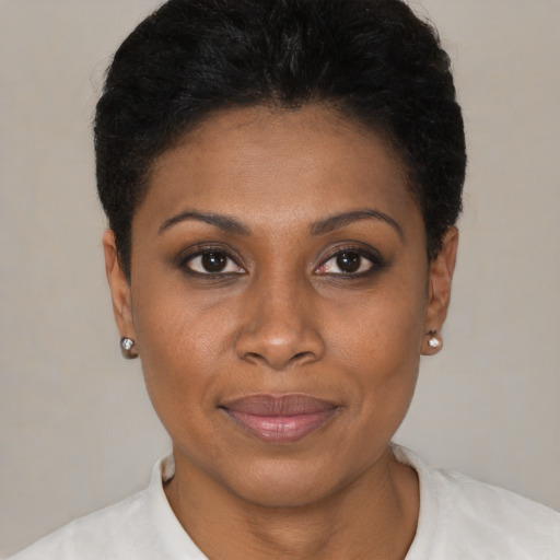 Joyful black young-adult female with short  brown hair and brown eyes