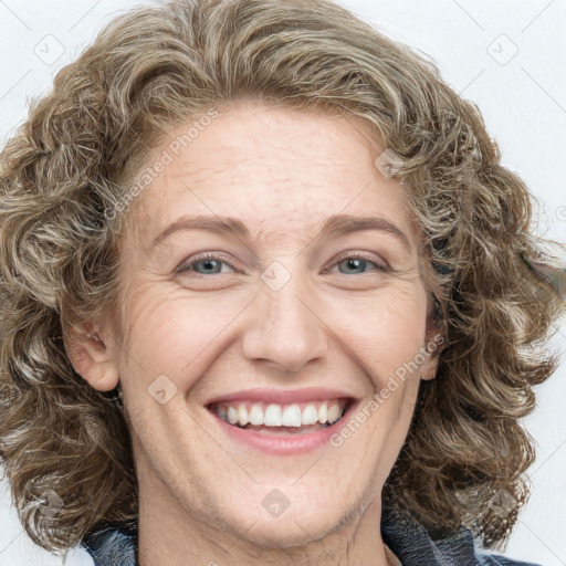 Joyful white adult female with medium  brown hair and blue eyes