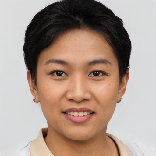 Joyful asian young-adult female with short  black hair and brown eyes