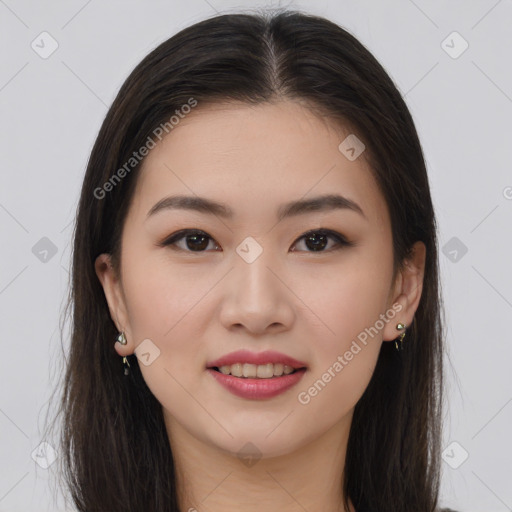 Joyful asian young-adult female with long  brown hair and brown eyes