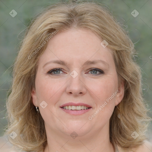 Joyful white adult female with medium  brown hair and blue eyes