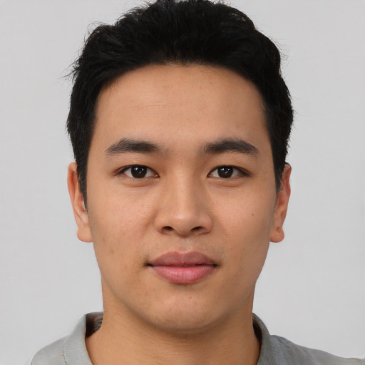 Joyful asian young-adult male with short  black hair and brown eyes