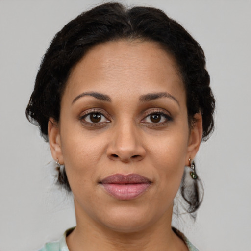 Joyful latino adult female with medium  brown hair and brown eyes