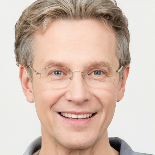 Joyful white adult male with short  brown hair and grey eyes