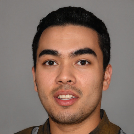 Joyful latino young-adult male with short  black hair and brown eyes