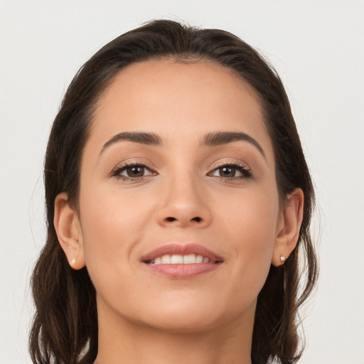 Joyful white young-adult female with long  brown hair and brown eyes