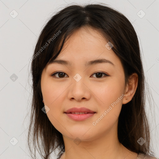 Joyful asian young-adult female with long  brown hair and brown eyes