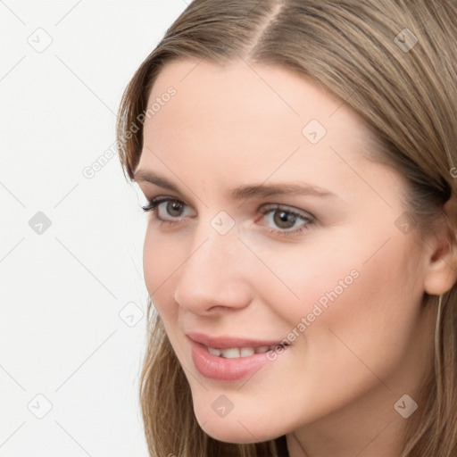 Joyful white young-adult female with long  brown hair and blue eyes