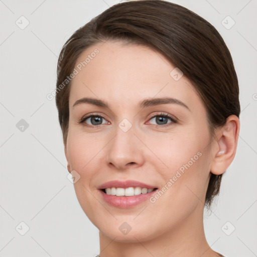 Joyful white young-adult female with short  brown hair and grey eyes