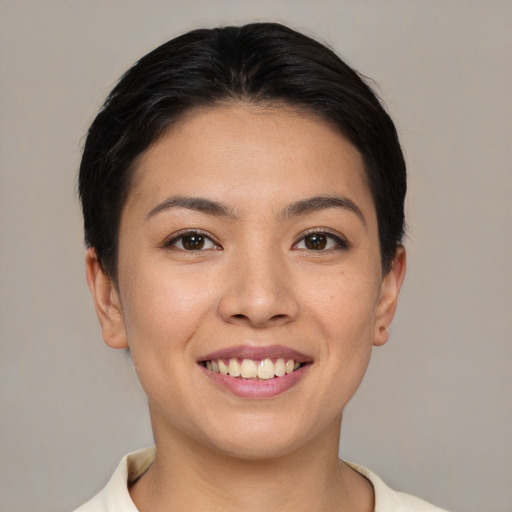 Joyful asian young-adult female with short  brown hair and brown eyes