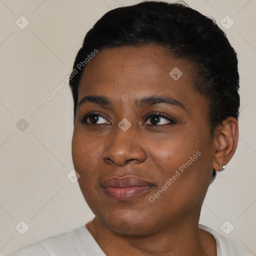 Joyful black young-adult female with short  black hair and brown eyes