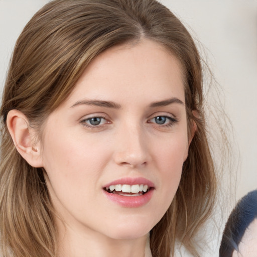 Joyful white young-adult female with medium  brown hair and grey eyes