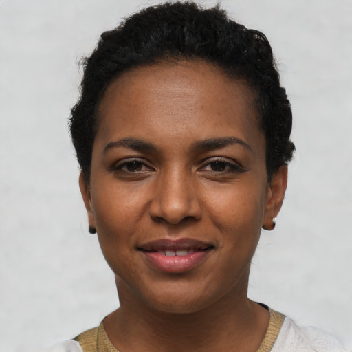 Joyful black young-adult female with short  brown hair and brown eyes