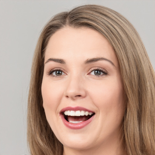 Joyful white young-adult female with long  brown hair and brown eyes