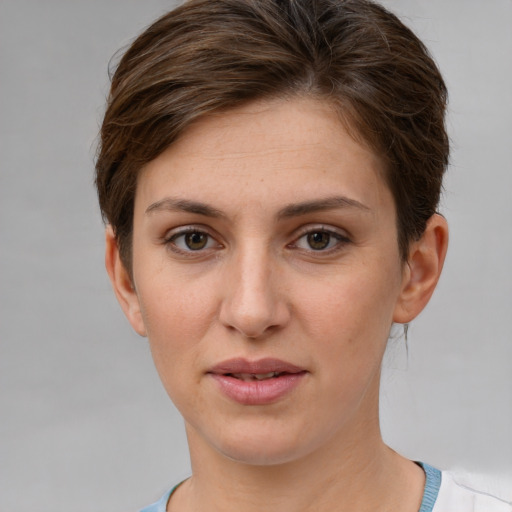 Joyful white young-adult female with short  brown hair and grey eyes