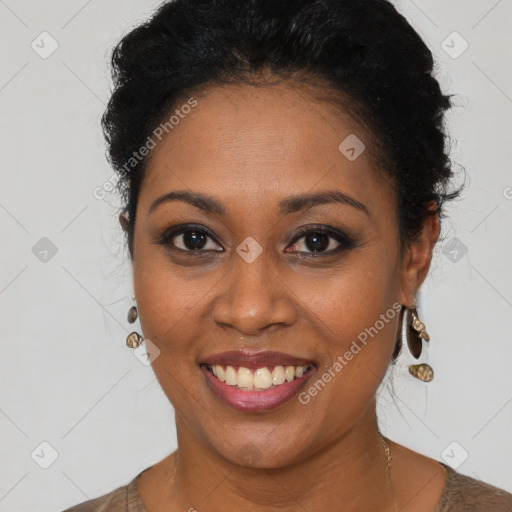 Joyful black young-adult female with short  black hair and brown eyes