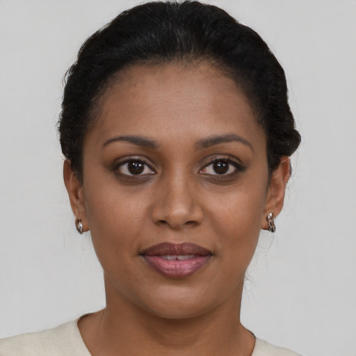 Joyful black young-adult female with short  brown hair and brown eyes