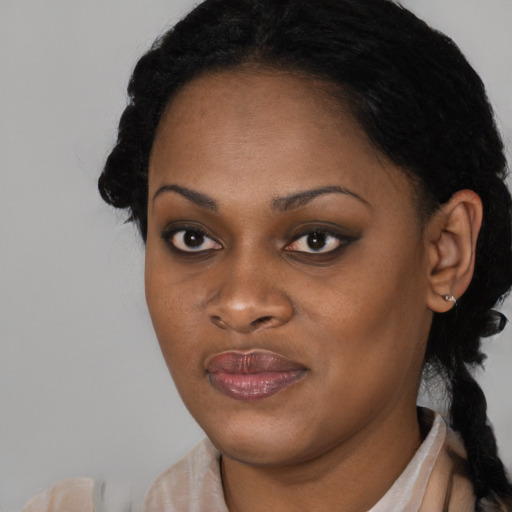 Joyful black young-adult female with long  black hair and brown eyes