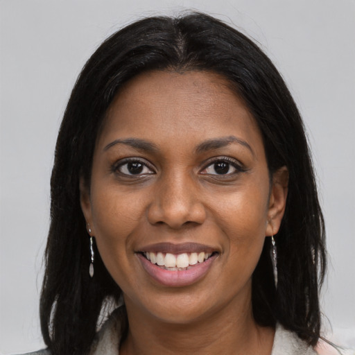 Joyful black young-adult female with medium  brown hair and brown eyes