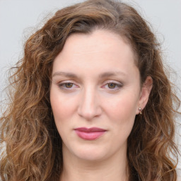 Joyful white young-adult female with long  brown hair and green eyes