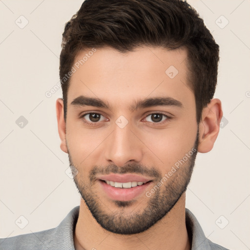 Joyful white young-adult male with short  brown hair and brown eyes