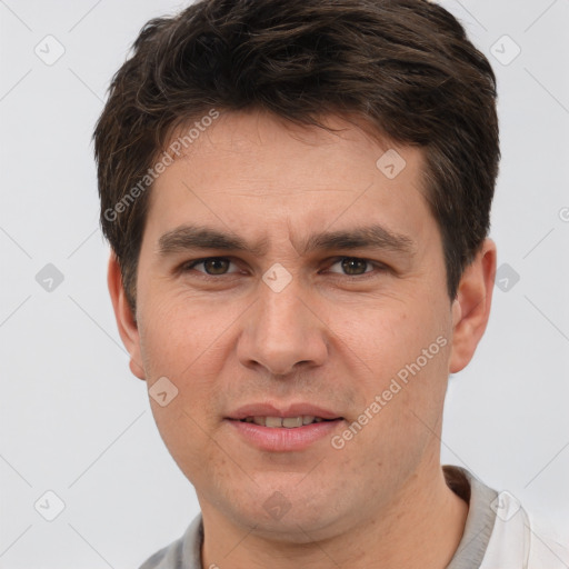 Joyful white adult male with short  brown hair and brown eyes